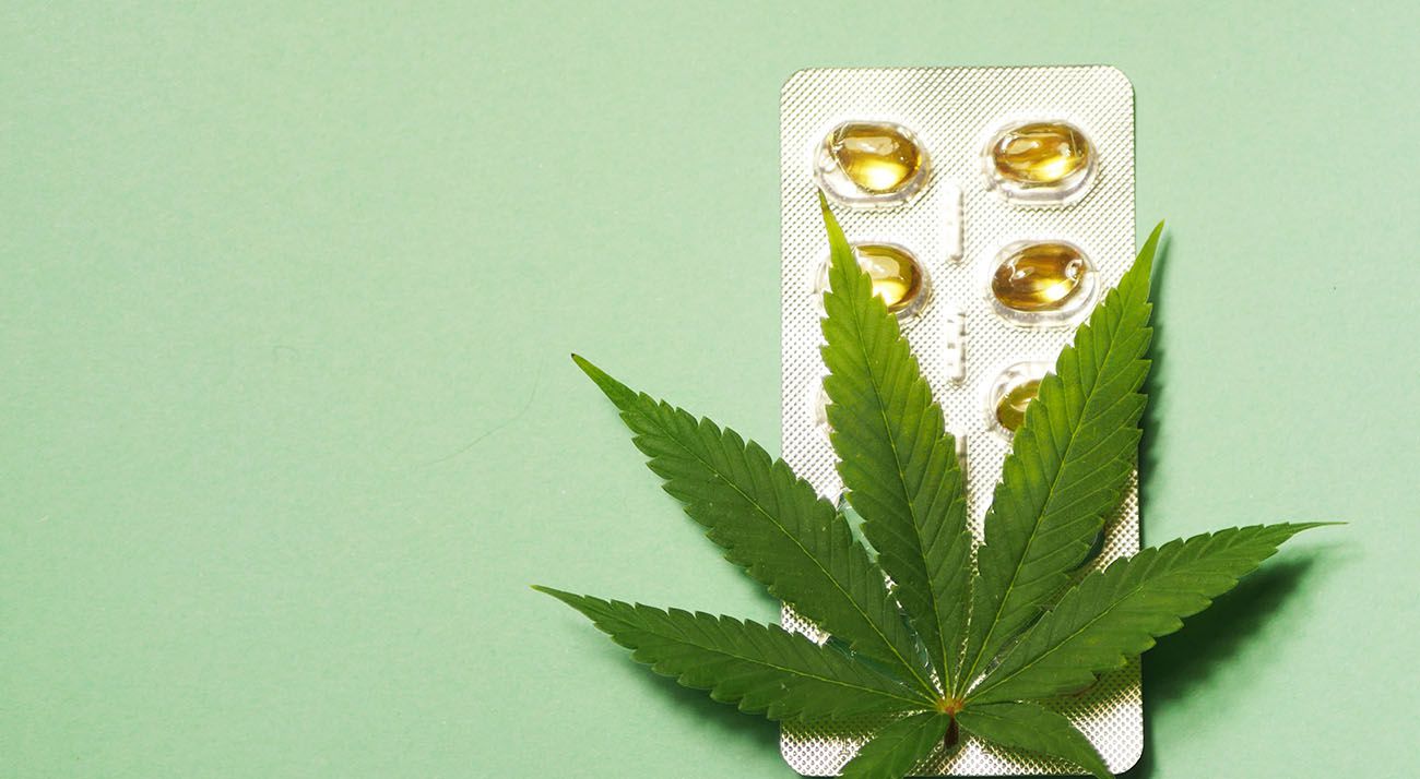 Cannabis leaf on top of pills
